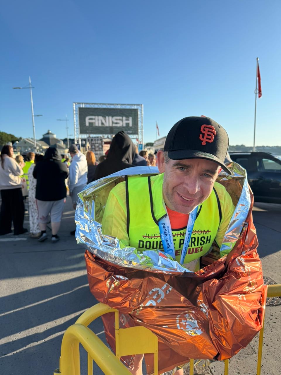 Martin Hall wrapped in a foil blanket at the Double Parish Walk finish line